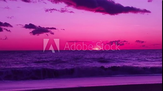 Spectacular pink purple sunset over ocean, waves breaking on beach. Amazing scene of sunset. Sunset Sky Natural Background. Sunrays, ray, Dramatic Sky.