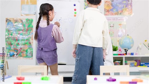 Young Asian Girl Solving Math Problems on Whiteboard in Classroom