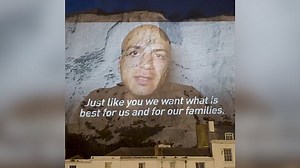 Syrian NHS worker pleads for compassion with video projected on Dover cliffs