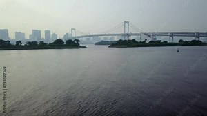 backwards close flying over water straight to rainbow bridge