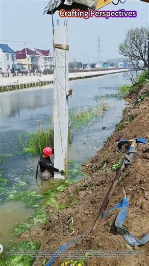 Manual Assistance Installing Precast Concrete Pile by River with Excavator