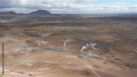 Hverir geothermal landscape captures steaming fumaroles and tourists from Námafjall mountain, ideal for Iceland travel and renewable energy concepts.