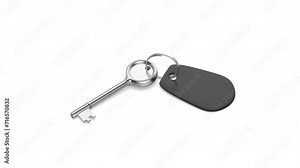 Silver old-fashioned key and blank black keyring on white background