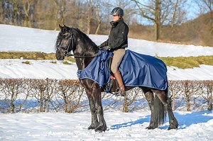 The Irish Leg Warmer from Bucas, great for the rainy cold days we are having at the moment as it keeps your horse warm and dry but also keeps you warm and dry as you ride out! The skirt on the rug wraps around you at the waist covering your legs to shield them from the elements and then it can be rolled up at the horse's shoulder if you get too hot! More info here: http://www.bucas.com/products/irish-leg-warmer-riding-rug/ | Bucas