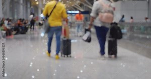 Blurred view: in spacious and contemporary airport terminal, passengers, including families with young children, leisurely walk towards boarding gates with trolley cases and backpacks.