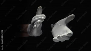 Gloved hands clapping on black background close up