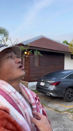 Adjusting a Cozy Striped Hooded Robe Outdoors