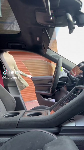 Woman in Green Dress Drives Sleek Modern Car