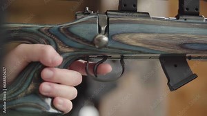 Lock and loading the chamber of rifle ready to pull the trigger. Handheld