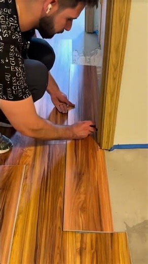 Installing interlocking wood-pattern vinyl planks along doorway edge