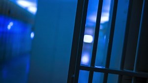 clip-1025596274-prison-cell-bars-door