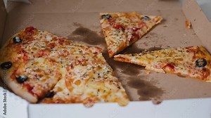 Hands taking pieces of pizza from cheese. Teamwork concept