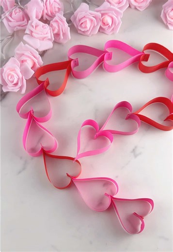 A simple way to make a heart garland using paper strips. Works for Valentine’s Day decor, gifts, or room styling. #papercraft #valentinesdecor #diydecor #paperhearts #craftideas