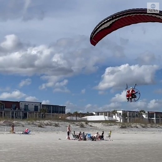 Santa traded in his sleigh for a powered parachute, which he used to glide through the air over Jacksonville Beach, Florida. https://abcn.ws/3mlkBzE | ABC News