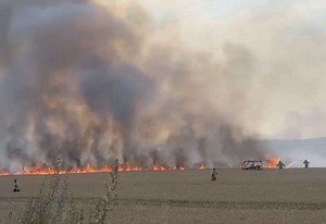 Firefighters battle wall of flames in field blaze