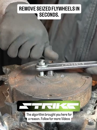🔥If your standard gear puller keeps slipping, turn a spare wrench into a custom extraction tool. Drill two holes in the wrench handle that align with the threaded ports on the flywheel. Place the wrench over the central shaft to act as a sturdy bridge, then thread bolts through it into the unit. As you tighten the bolts evenly, the heads press against the wrench, forcing the stuck flywheel to lift off the tapered shaft safely. Save this hack for your next small engine repair. #mechanic #flywhee