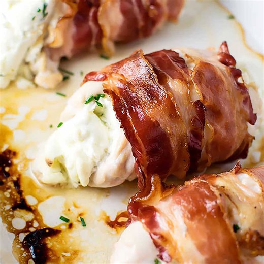 Bacon Wrapped Cream Cheese Stuffed Chicken! A base recipe for tender chicken breast stuffed with cream cheese and chives wrapped tightly within crispy bacon. Make it as written or add more flavors! GET THE RECIPE: https://homemadehooplah.com/bacon-wrapped-cream-cheese-stuffed-chicken/ | Homemade Hooplah