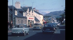 Vintage film of a bygone era showing the remote village of Tomintoul with local hotels the Glen Avon and Gordon Arms, plus shops, including Campell's Corner Store and the Glenlivet Whisky Depot, the highest licensed shop in the highlands. The film then shows Crathie Kirk by Balmoral, and finishes with Newtonmore, showing shops in the centre of the village and the Highland Folk Museum. This is a scan of an old home movie cine film, showing a family on holiday in Aberdeenshire and the Cairngorms i