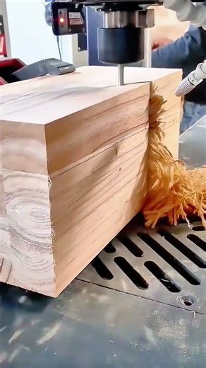 A man uses a jackhammer tool to demolish a concrete wall section