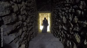 Knight girl in a flowing cloak is the catacombs of an ancient castle