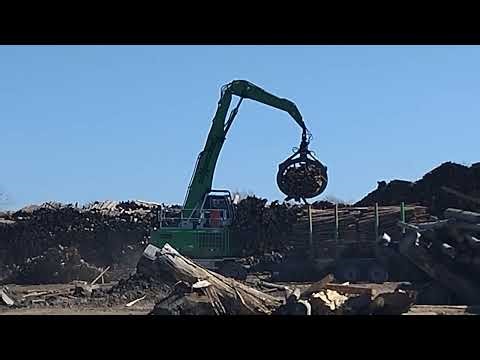 Jcb pulling the logs.