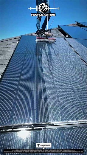 Skilled People Cleaning Solar Panels Using Brush During Rooftop Maintenance Action