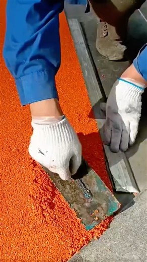 Applying Bright Orange Rubber Surface for Sports Track Construction