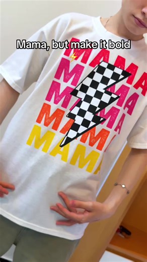 Checkered vibes with a lightning twist. Perfect summer tee for cool, confident mamas. Easy to style, impossible to ignore. #MamaStyle #SummerTee #LightningBolt #TrendyMom #GraphicTee