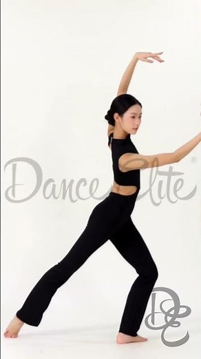 The woman performs a graceful, flowing dance in a black cut-out outfit.