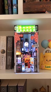 "It feels like I’m in Tokyo again! 🇯🇵✨ This book nook perfectly captures the charm of Omoide Yokocho, from the tiny ramen shops to the warm glow of the lanterns. The details are incredible, and the building process was so relaxing. Now, every time I see it on my shelf, I’m instantly transported back to my Tokyo adventure!" - Laura A. Craft yours today → https://byanavrin.com/products/omoide-yokocho-book-nook-anavrin/ | Anavrin
