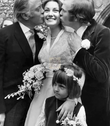 "Circa 1971, actress Jane Seymour and her first husband, theater director Michael Attenborough, were photographed on their wedding day at the Church of St. Mary in England, radiating youthful joy and elegance. Seymour, then at the dawn of a career that would soon make her an international star, looked radiant in her bridal gown, while Attenborough, son of actor-director Richard Attenborough, stood proudly at her side with charm and distinction. Their ceremony, set against the timeless beauty of 