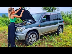 girl driving car tire spinning wheel on the grass pedalpumping