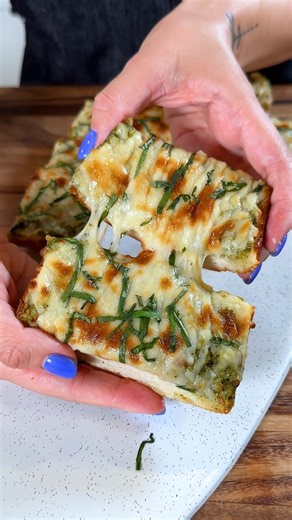 CHEESY PESTO GARLIC BREAD | Find the full recipe here: https://sweetsimplevegan.com/cheesy-pesto-garlic-bread/ | Sweet Simple Vegan