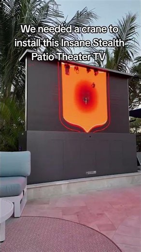 We needed a crane to install this Insane Stealth Patio Theater TV #insanepools #lucaslagoons #tv