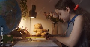 Child with Globe, technology for school girl looks at globe, explores world, learns. Child is studying while sitting at home in rays sun in room. Kid in morning light, doing school homework homework