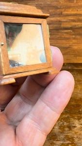 Miniature clock box celebrates Christmas with a colonial holiday theme inside, including a copper bed warmer in the corner, and a teddy bear sitting on a ladder back chair. This piece may be considered antique as it was made in 1983. #Dollhouse #Miniature #Christmas. | D. Thomas Miniatures