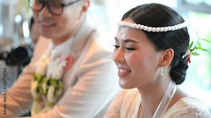 Asian bride on hands pouring blessing water into groom and bride's bands Stock Video