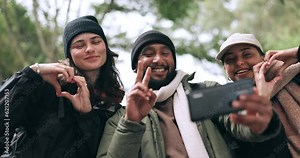 Friends, forest or hikers taking a selfie while hiking outdoors in nature sharing the experience on social media. Winter, happy or active people take a picture or a photo while trekking together