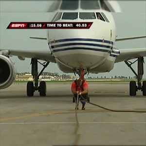Brian Shaw, Travis Ortmayer, and Terry Hollands pull a massive 48 ton plane as fast as possible. | SBD World’s Strongest Man