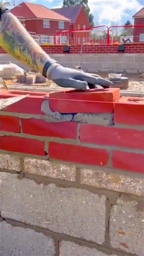 Detailed process of carefully laying bricks to build a strong and even wall