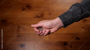 Hand tossing coin to flip on heads or tails and catch it on the fly. Slow-motion