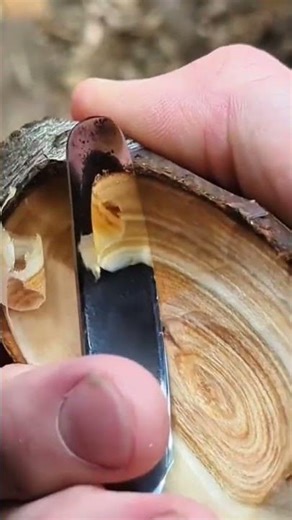Carving a hollow wooden bowl by slicing smooth layers and shaping curves with steady control manual