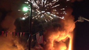 Fireworks explode over blaze