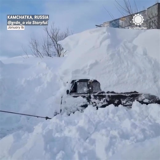 People dig out their cars after a powerful snowstorm dumped several feet of snow across parts of Russia’s Kamchatka Peninsula. | AccuWeather