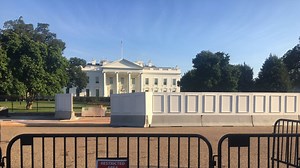 Construction starts on taller White House fence, giant panels block views