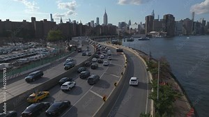 flying alongside FDR Drive traffic towards midtown NYC skyline