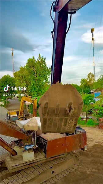 Excavator Digging in Lush Outdoor Landscape