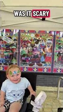 Trying to make my gorgeous sassy niece smile during her face painting...