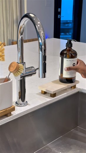 🔑 Phrase: SINK Is it just me, or did chores turn into self-care? 😆 Kitchen sink styling, towel folding… younger me would be concerned, but current me is thriving. 😂 My Kitchen Sink Essentials: Wooden & travertine risers Dish sponge holder Brush holders Glass, pot, and dish brushes Dish soap #kitchendecoration #kitchendesign #cleaning #cleaningproducts #homedecor | decor.snippets