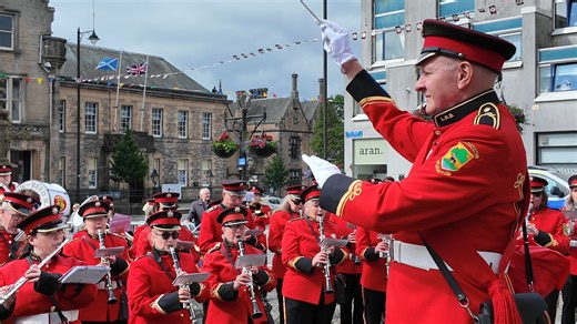 Linlithgow Reed Band, led by Conductor Lex McDowell, performing 'Highland Cathedral' by the Cross Well and Burgh Halls in Linlithgow. This was on the morning of Tuesday 17th June 2024 and part of the Linlithgow Marches, as they prepared to lead the march up to Linlithgow Palace. The Royal Burgh of Linlithgow Reed Band is one of very few civilian bands in Scotland which has a military configuration, in that it includes reed, brass and percussion instruments. They undertake a wide variety of march